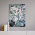 Abstract painting on a wall with decorative vases below.