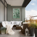 Modern outdoor living space with a sectional sofa, potted plants, and a painting on a wall.