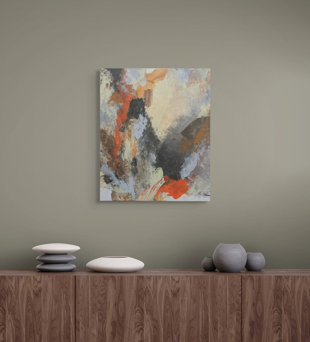 Abstract painting on a wall above a wooden cabinet with decorative items.