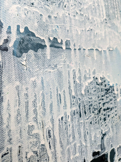 The image is a close-up of a textured surface with a white and black color scheme, featuring a pattern of dripping or dripping paint.