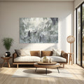 Modern living room with a brown sofa, round coffee table, and abstract painting on the wall.