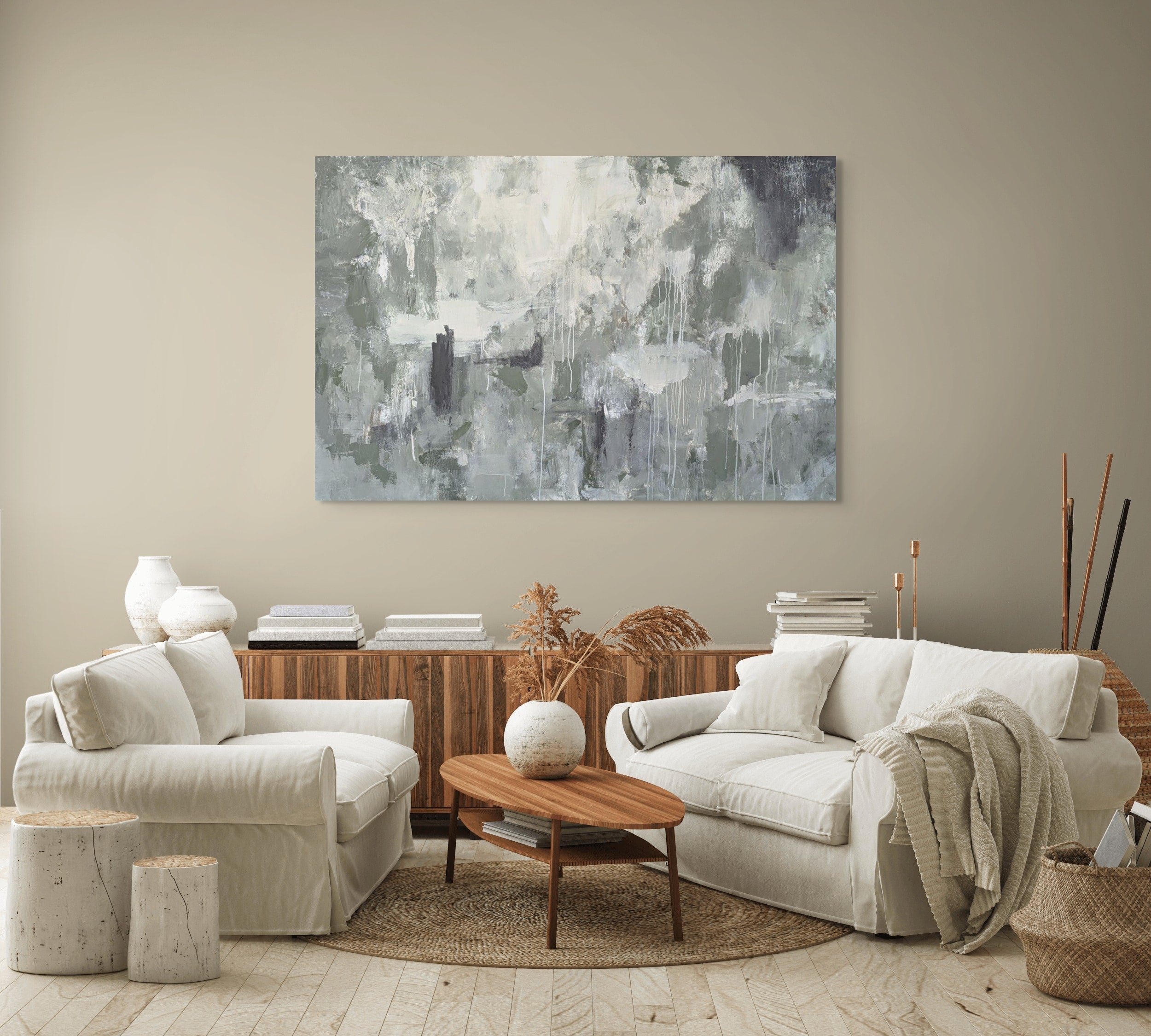 Living room with white sofa, wooden coffee table, and abstract painting on the wall.