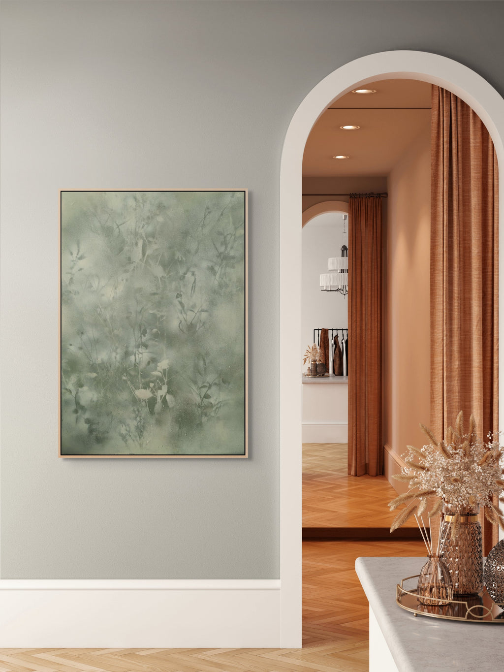 Living room with abstract painting on wall, archway leading to another room.