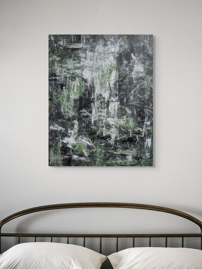 a large abstract painting hanging on a wall above a bed with a metal headboard.