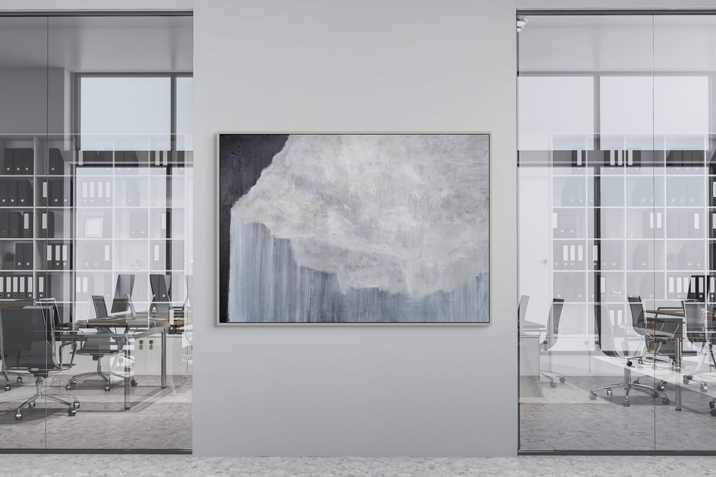 Modern office interior with a large abstract painting on a wall.