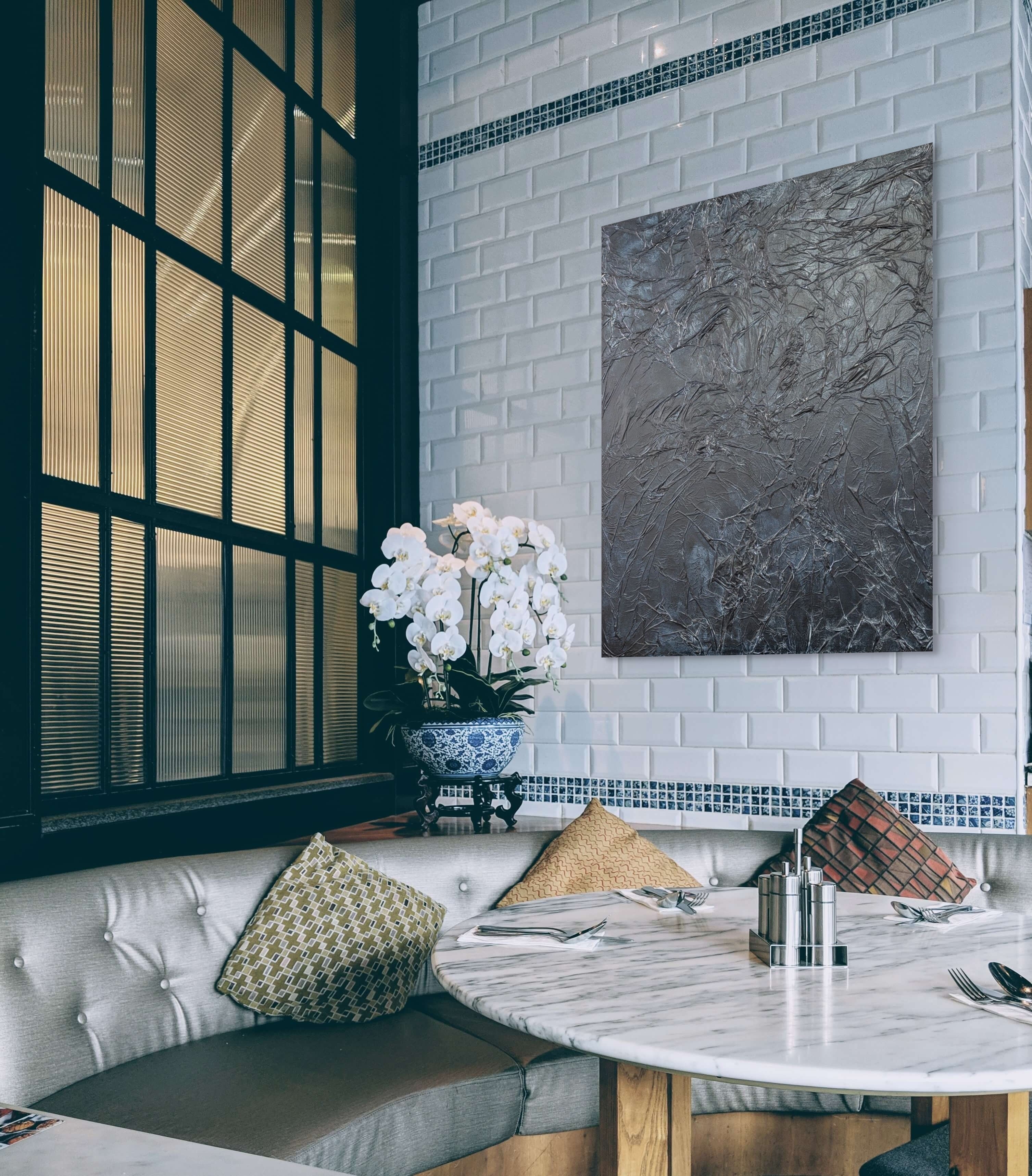 Modern interior with a white brick wall, marble table, and decorative elements.